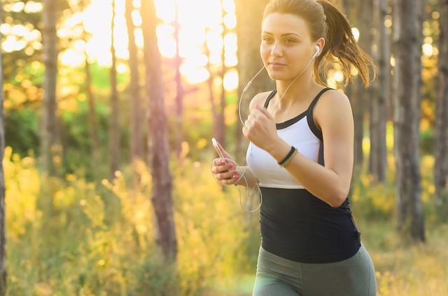 Lady Jogging in Park with Headphones shedding pounds