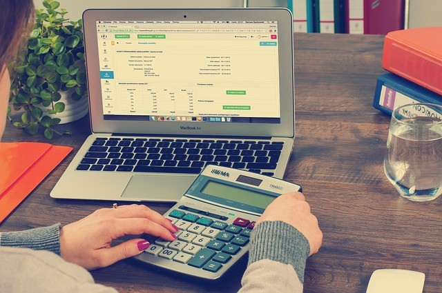 Woman using calculator group insurance