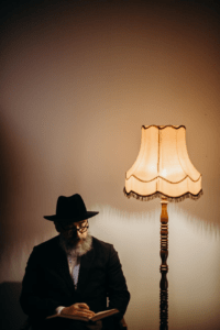 Lamp in room with senior bearded man